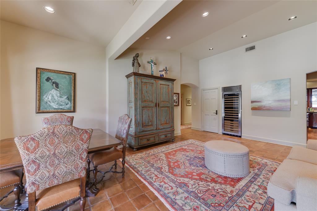 The adjacent SITTING ROOM (14 X 16) includes Saltillo tile flooring, recessed lighting, doors to covered patio overlooking Pool, window with Roman shades raised ceiling, pantry closet, stainless Viking wine refrigerator.