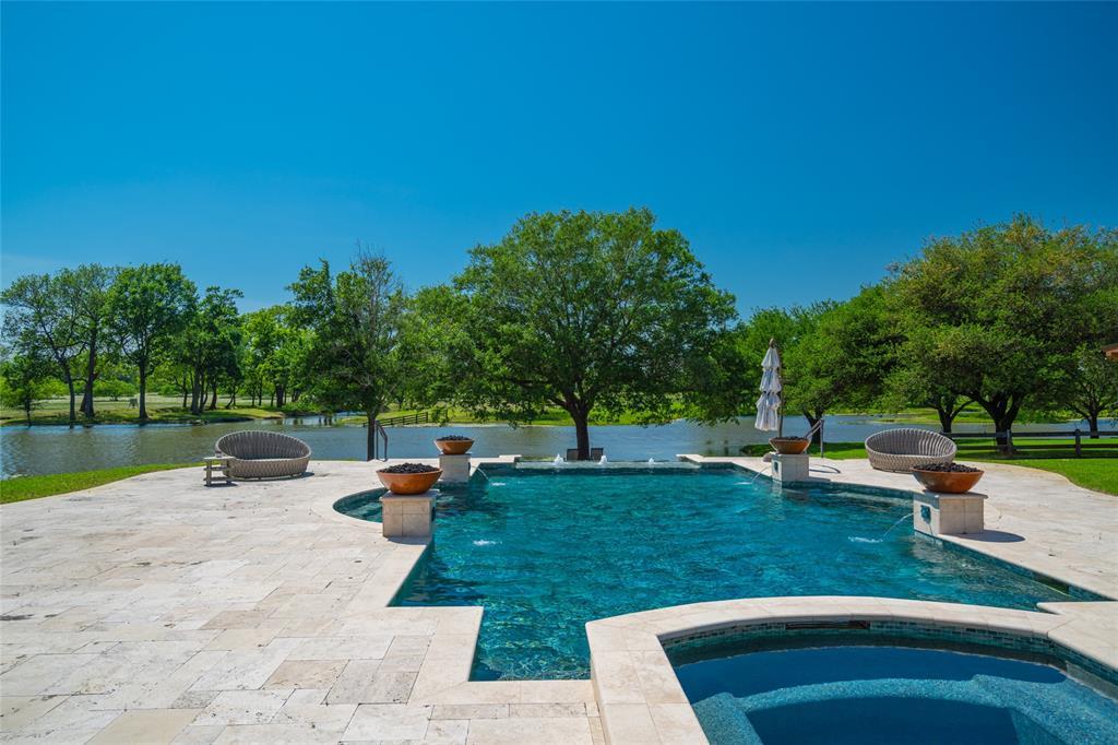 Another view of the BACKYARD POOL looking outward through the majestic trees to the lake beyond.  What a great spot to relax and enjoy all the fabulous scenery and vistas!