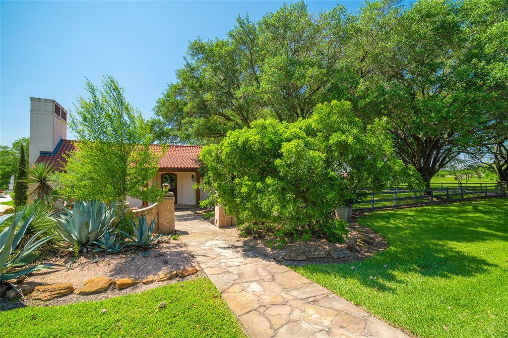 The GUEST HOUSE is the original house to the ranch - restored in 2001- and beautifully appointed with an inviting stone walkway and gate entry, wood fencing, ageless stucco exterior and handsome tile roof - all surrounded with native plants, canopied trees and rock gardens.