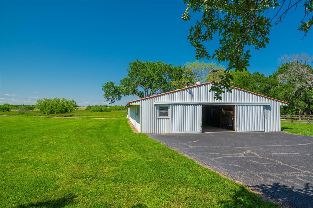 An EIGHT STALL HORSE BARN including an office, conference room and workshop.