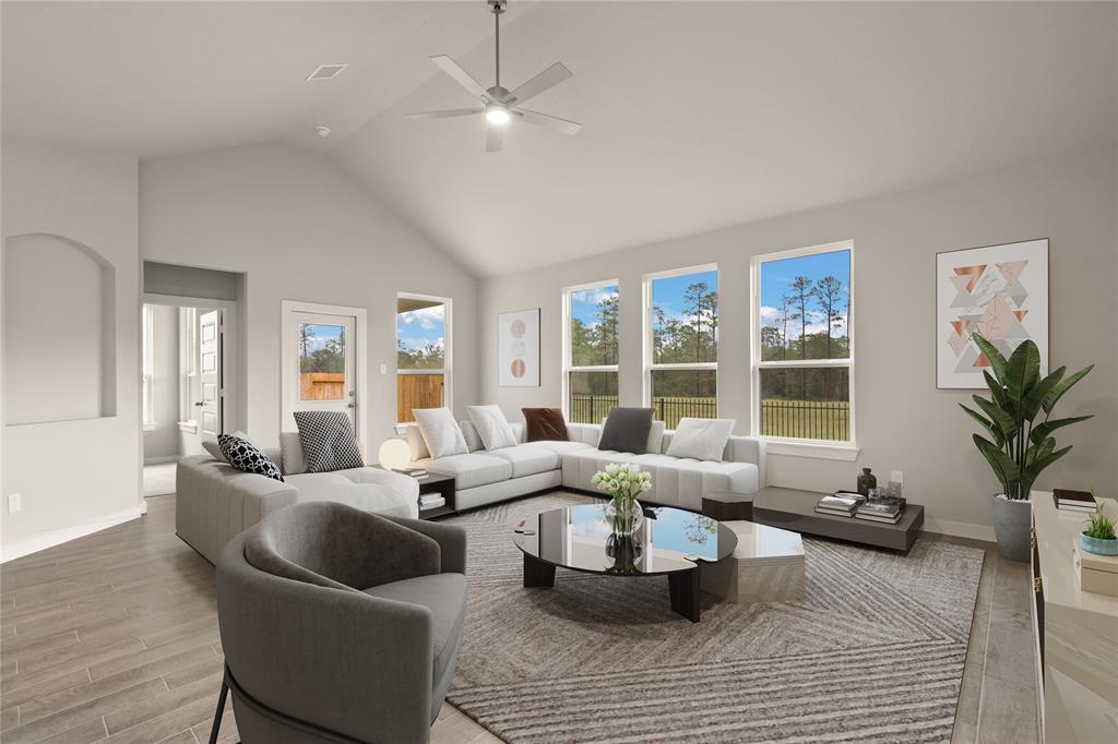 Gather the family and guests together in your lovely living room! Featuring high ceilings, recessed lighting, dark stained ceiling fan, custom paint, gorgeous floors and large windows that provide plenty of natural lighting throughout the day.
