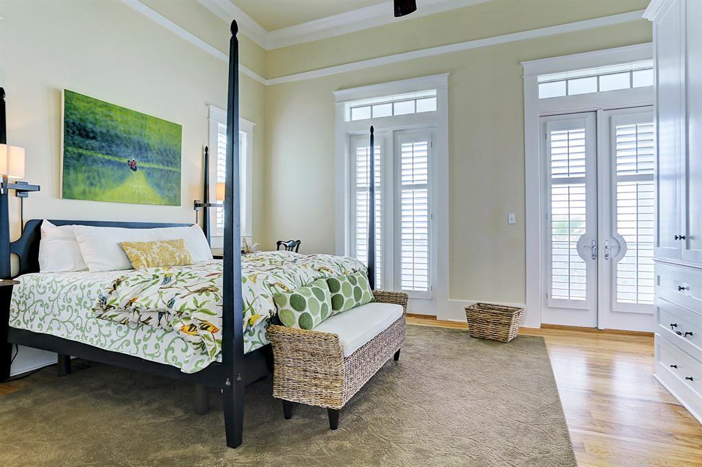 Light-filled Master Suite featuring hardwood floors, porch access, and high ceilings.