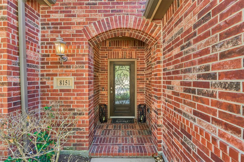 Graceful brick front porch, elegant Cantera style front door
