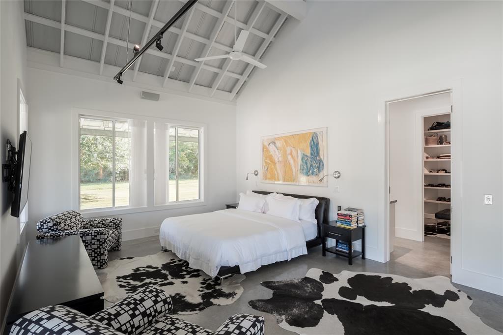 The primary bedroom is adorned with high ceilings and modern fixtures