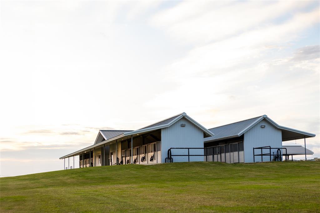 Twin mirrored barns that Include 20 stalls, an office, feed room and tack room.