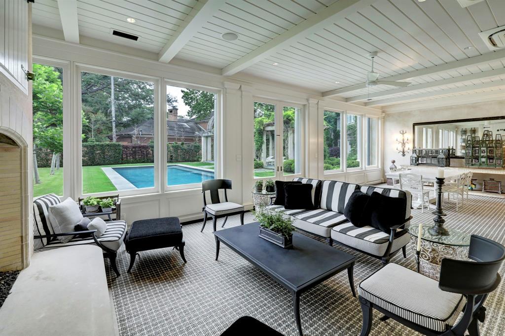 The Screened Porch is a relaxing space with views and access to the pool, pergola and backyard.