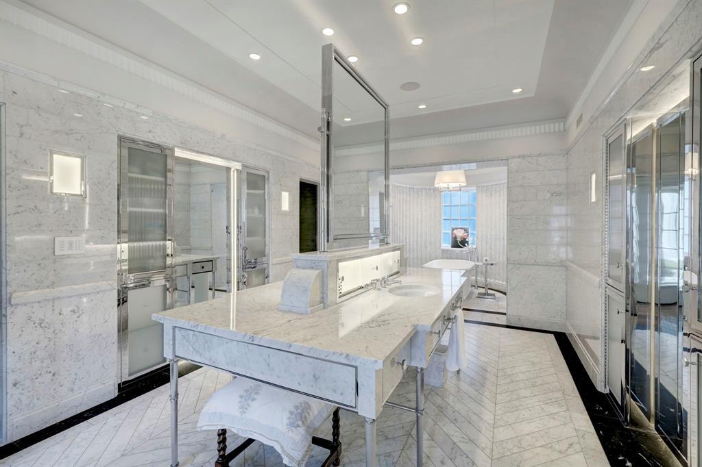 Luxurious primary bath with marble detailing.