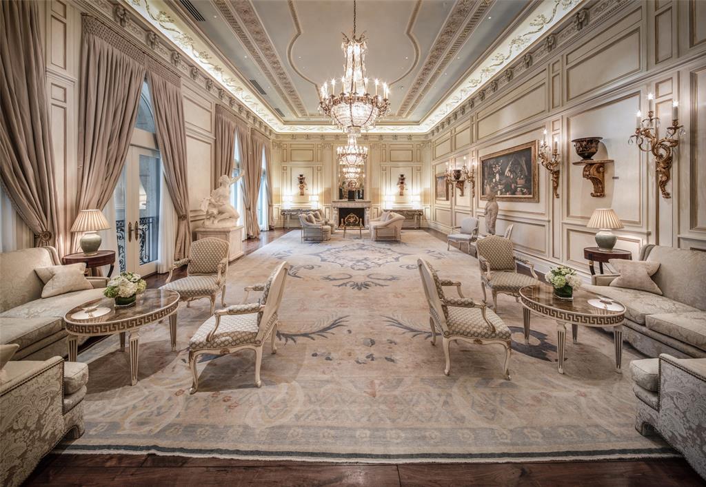 Timeless elegance! The eye is drawn to the 16-foot-tall, coved ceiling where leaf and berry garlands gracefully encircle twin chandeliers. French salon wall panels are finished with gilt-edge framing and floral appliques.