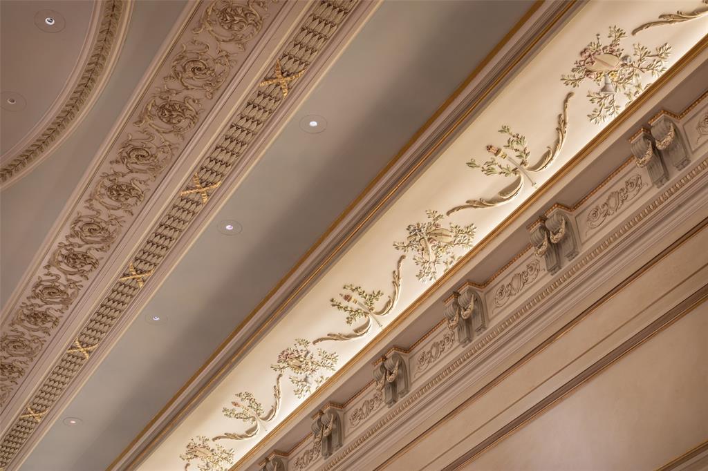 Handcrafted ceiling borders by European artisans delight the senses with floral appliques featuring 18th century musical instruments.