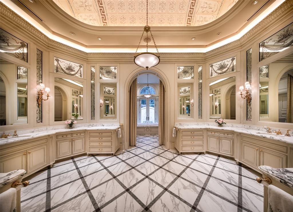 The octagonal en suite Spa Bathroom impresses with a tray ceiling and swaths of marble surrounding separate vanities.