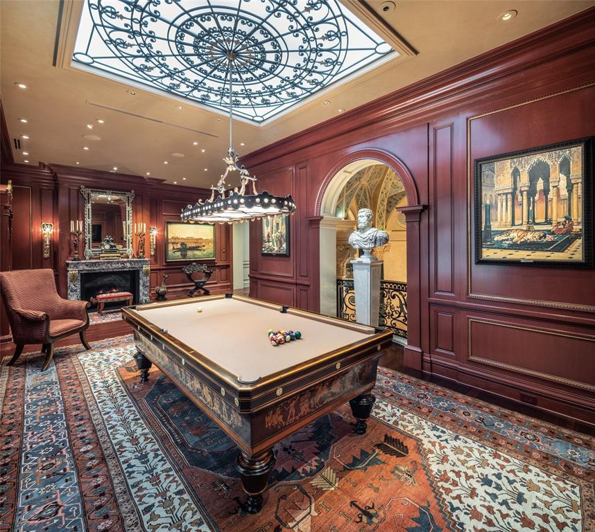 Billard Room features paneled walls in French salon styling with gilt edged framing, opaque glass skylight overlaid with custom decorative grillwork medallion.