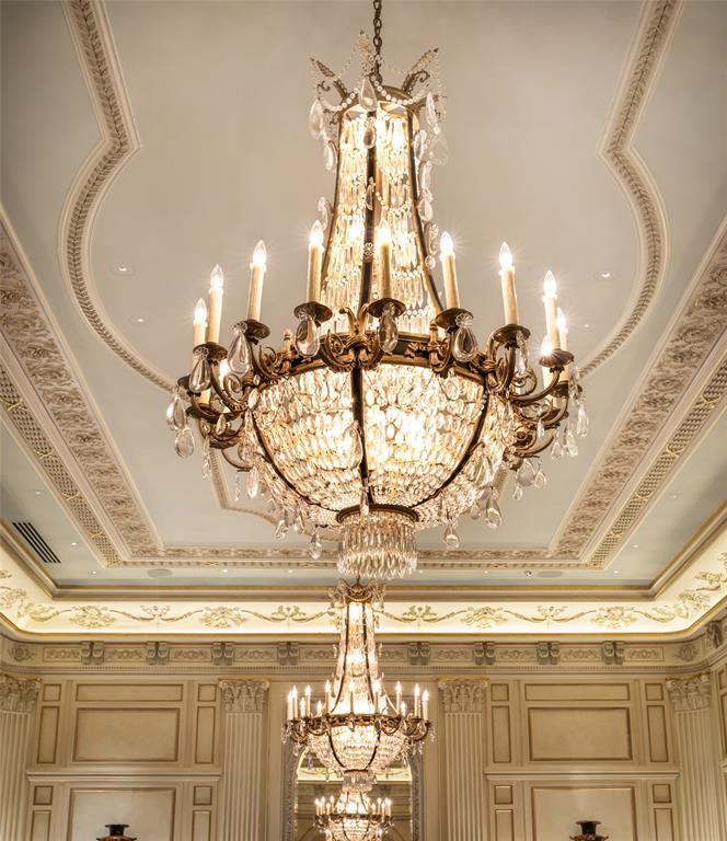 Each crystal chandelier dazzles with cascading prisms and drops catching and reflecting the light below embossed medallions.