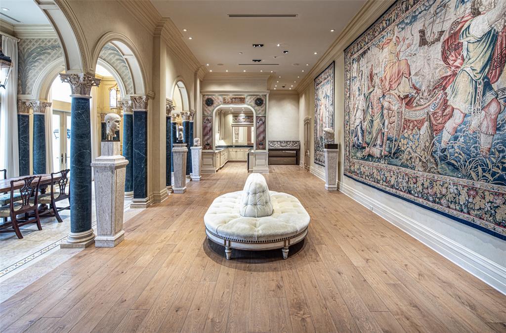 The Family Room can also be utilized as a regal gallery reception hall when entertaining guests alongside a marble walk-up bar, Venetian plaster walls and magnificent marble columns with carved Corinthian capitals.