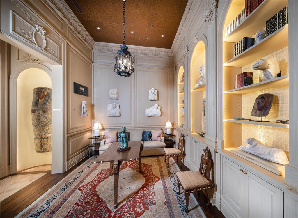 Refuge in the palatial estate can be found in this cozy study designed with coved ceiling of hand-crafted leather with ornamental acanthus leaf crown folding and beading. Enjoy reading and relaxation.