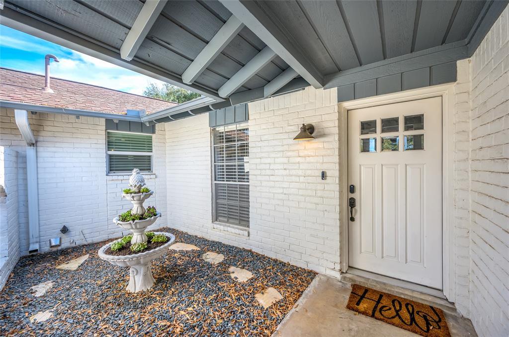 A private walled atrium at the front of the home creates a welcoming entrance.