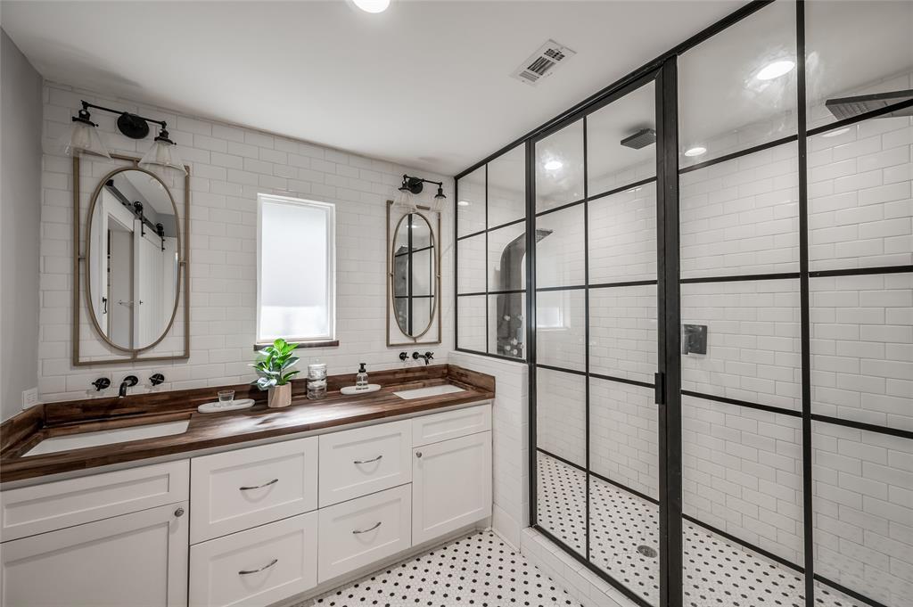 So many great features in the owner's bathroom – dual vanity with drawers and cabinet space, large walk-in shower with multiple shower heads, and a walk-in closet with built-ins.