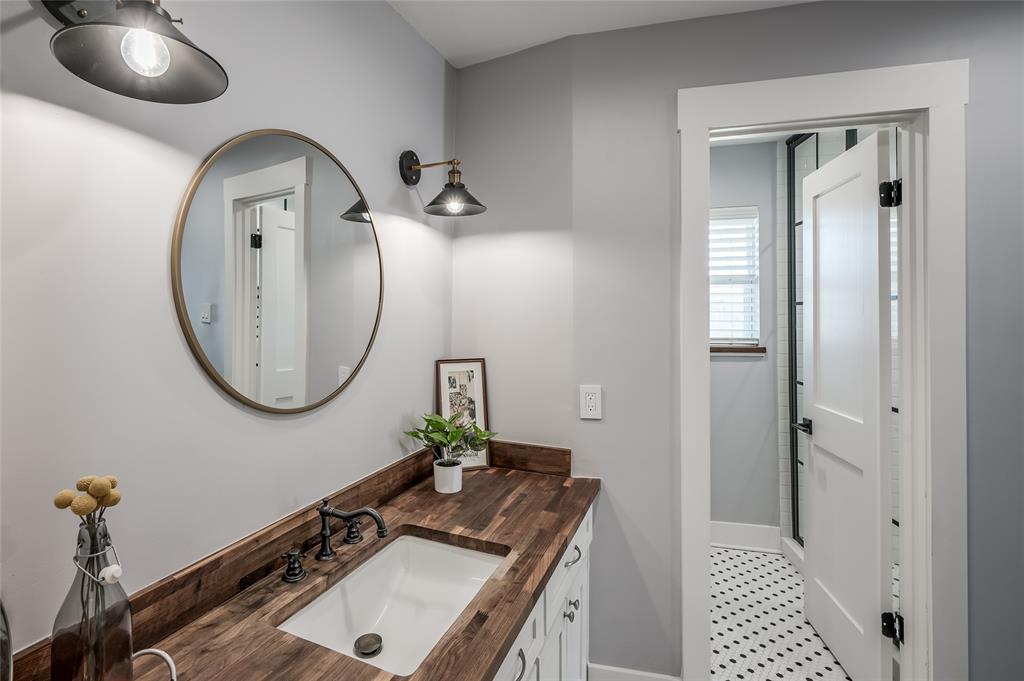 An open vanity area is adjacent to the private shower and toilet room.