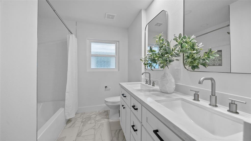 Welcome to a bathroom that's designed to delight the senses and rejuvenate the soul. Dual vanities provide ample counter space for your daily routine, while elegant fixtures and mirrors enhance the overall aesthetic.