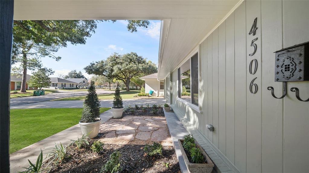 The meticulously manicured landscaping frames the entrance, offering a welcoming embrace that hints at the beauty within. Lush greenery, vibrant flowers, and well-placed shrubs create an inviting pathway that leads to the front door.