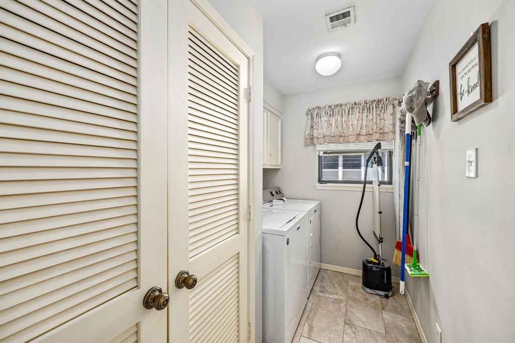 Roomy laundry room with a storage closet.