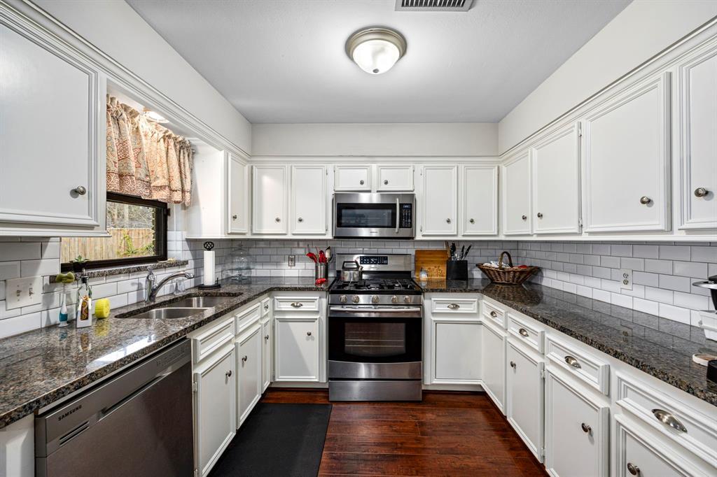 Tastefully upgraded kitchen with granite countertops and stainless-steel appliances.