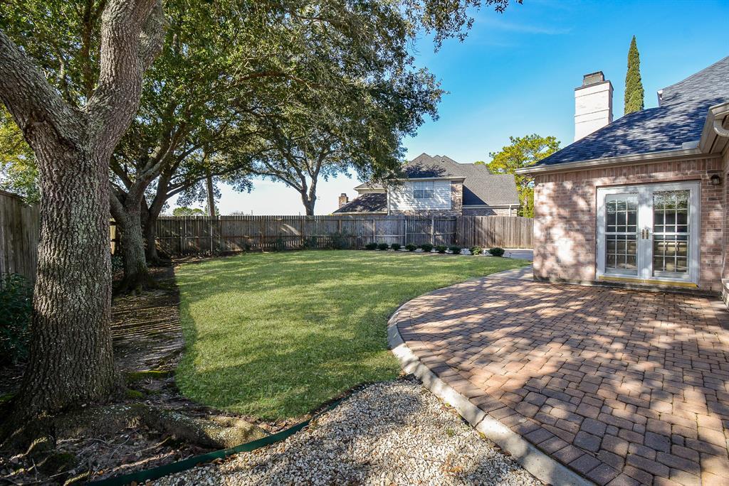 Backyard showing pool size yard and pavers for easy maintenance!