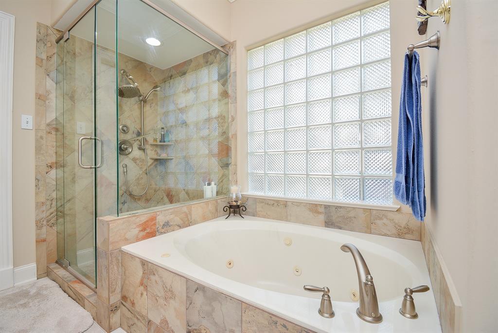 Primary bath with jacuzzi tub with separate shower and glass block windows!