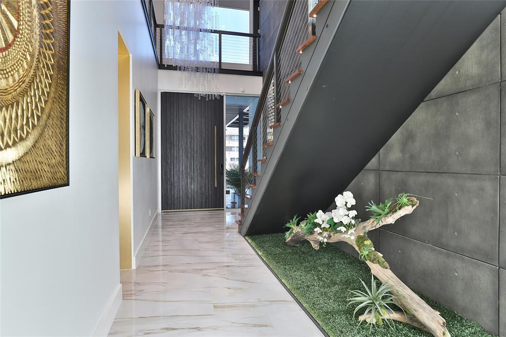 Every room upstairs overlooks the Zen like foyer. Sprawling 20' ceilings shroud the first floor and the wall of triple pane windows lend natural light.