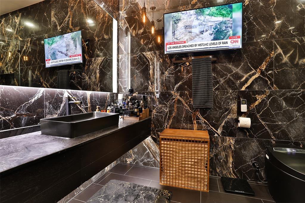 Stunning Nero leathered black/aria stone quartzite counters accent "His" bathroom.
