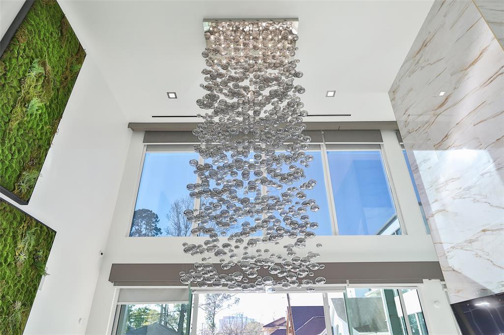 The custom hand blown glass smoke bubble chandelier was made specifically for this space and is ONE OF A KIND.