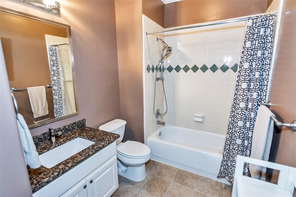 Updated guest bath with new vanity, granite counters, faucet, light fixtures and toilet.
