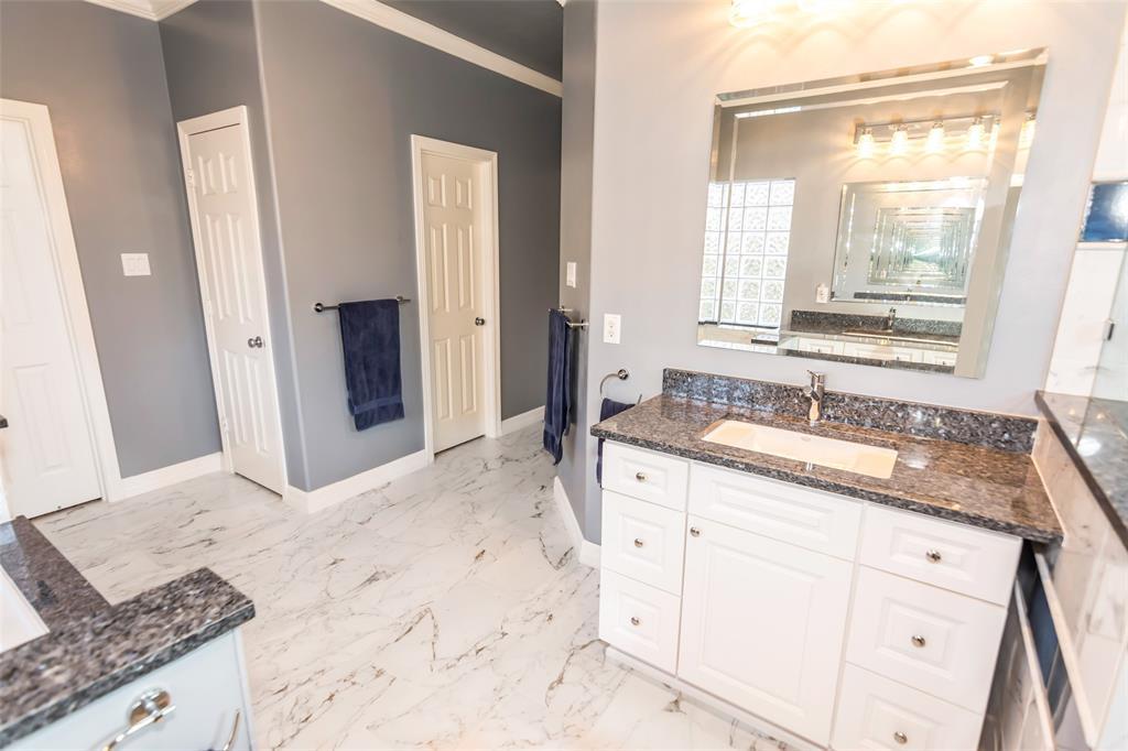 Vanity 2 with lots of storage, granite counters, beveled glass mirror and rectangular sink.
