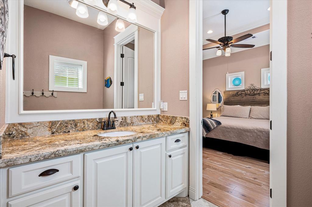 The primary suite has a nice-sized private bath with stone tile floor and granite vanity.