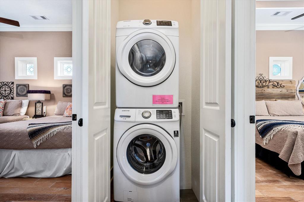 Full-size stackable washer and dryer conveniently located near bedrooms.