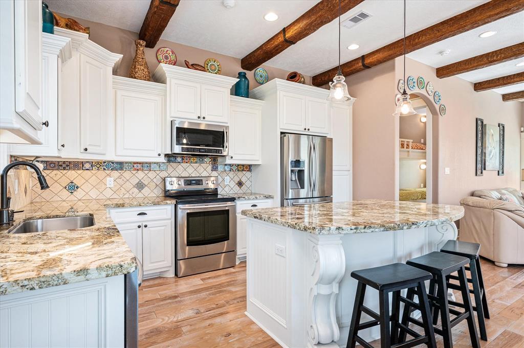 A huge kitchen island with breakfast bar is a great gathering and serving spot.