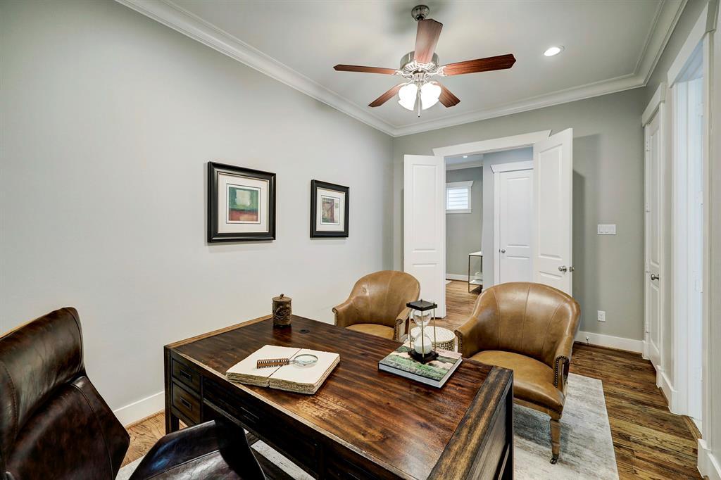 Both secondary rooms offer soft, neutral carpet, well-designed closet space, ceiling fans, and beautiful windows dressed with custom white shutters, ensuring comfort, functionality, and a touch of timeless elegance in every detail.