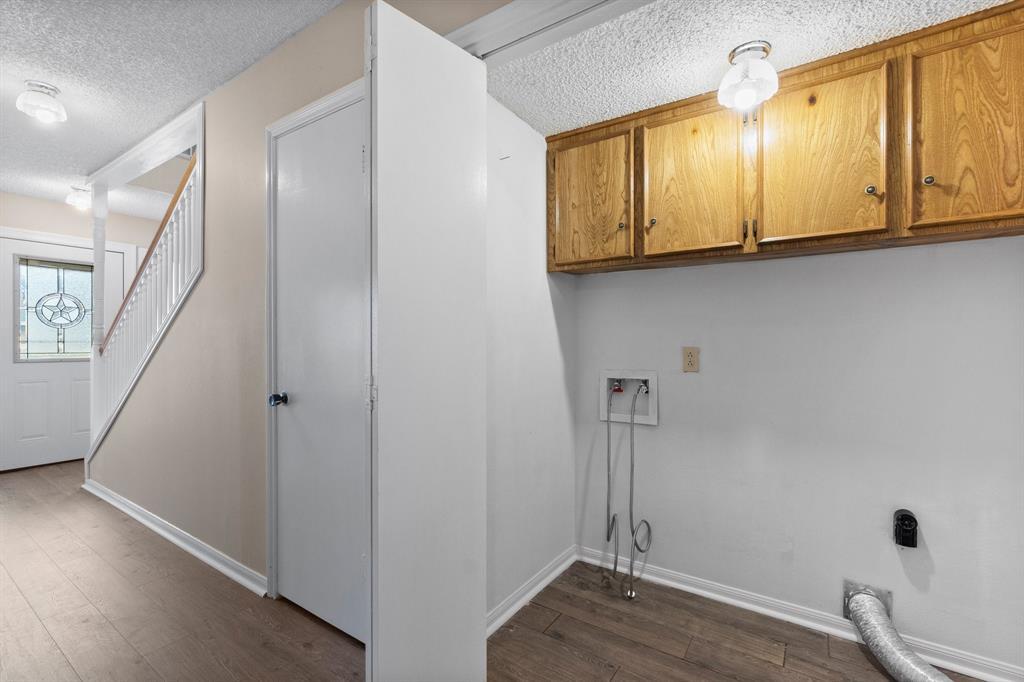 Laundry room accommodates full size washer & dryer with above appliance storage. Additional storge in next door under stairwell.