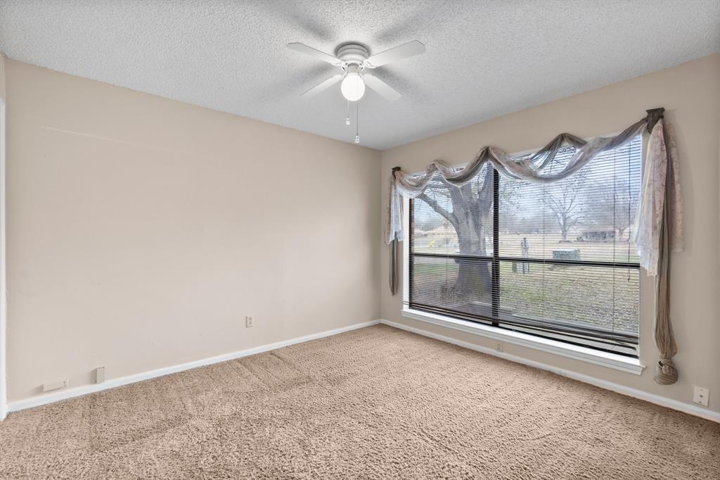 The second guest room has a lot of natural light and a large walk-in closet that could also be used as an office area or study.