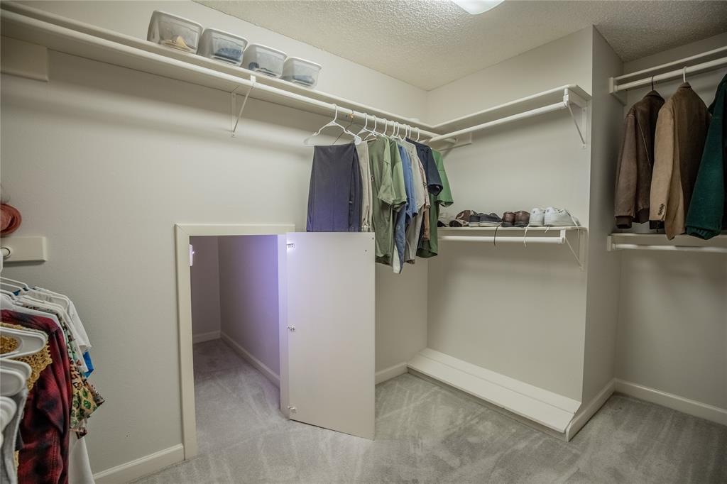 Additional view of the primary bedroom closet.  Note the small doorway to the luggage closet.