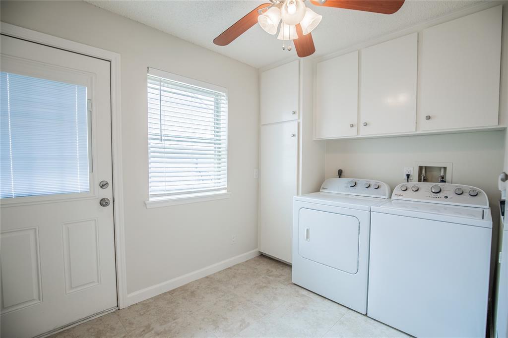 Large utility room with extra storage and a built-in ironing board.