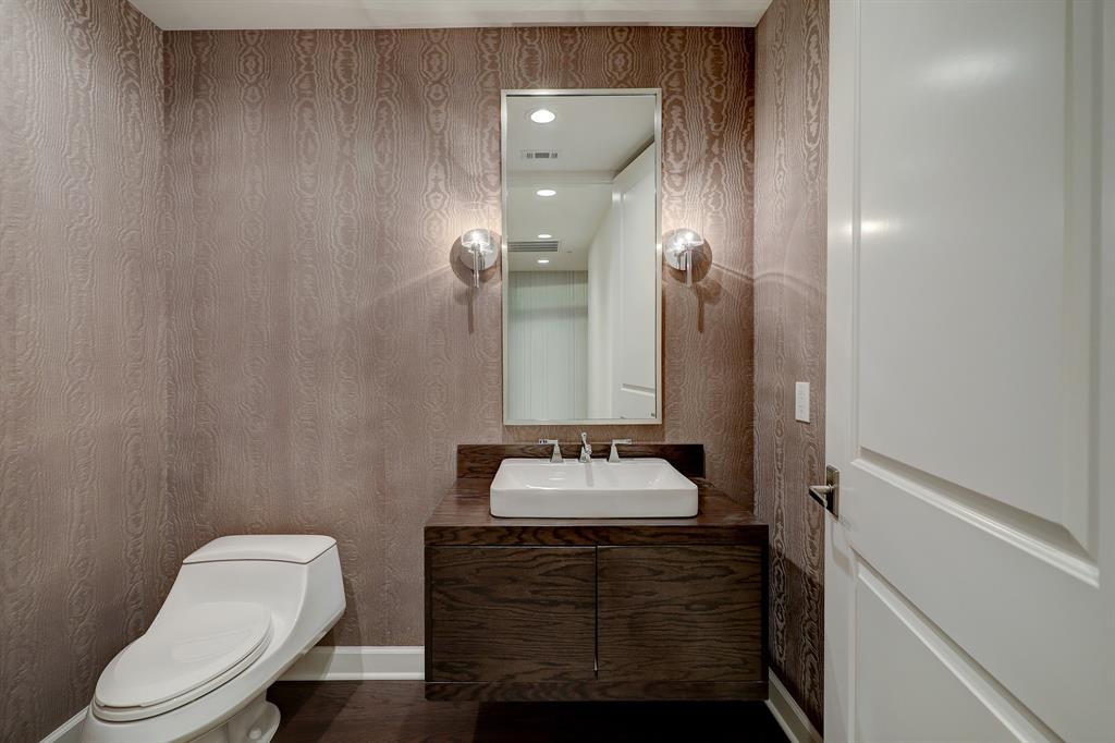 The lovely powder room has a modern vessel sink.