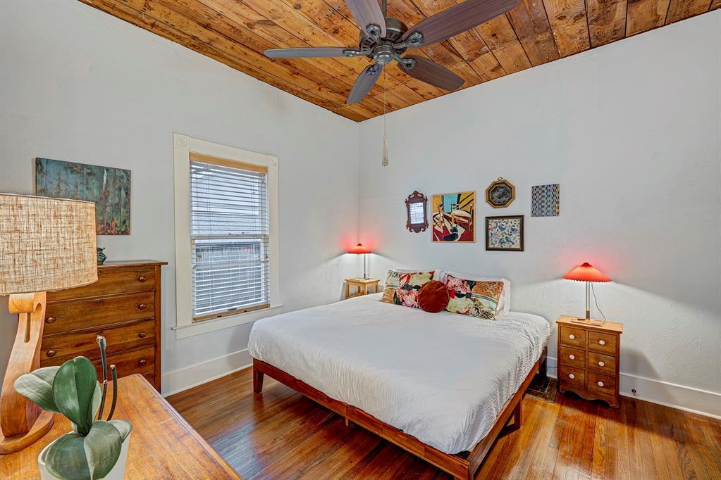 Downstairs primary bedroom boasts exposed ceiling shiplap and walk-in closet.