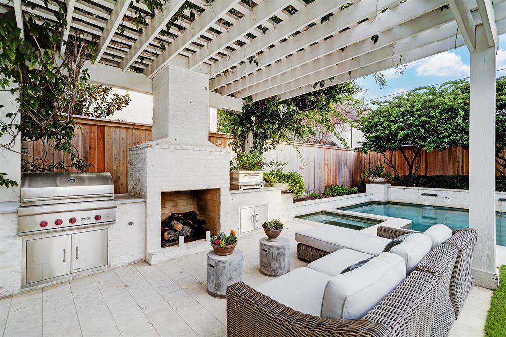 Relax under this pergola with gas grill and cozy fireplace.