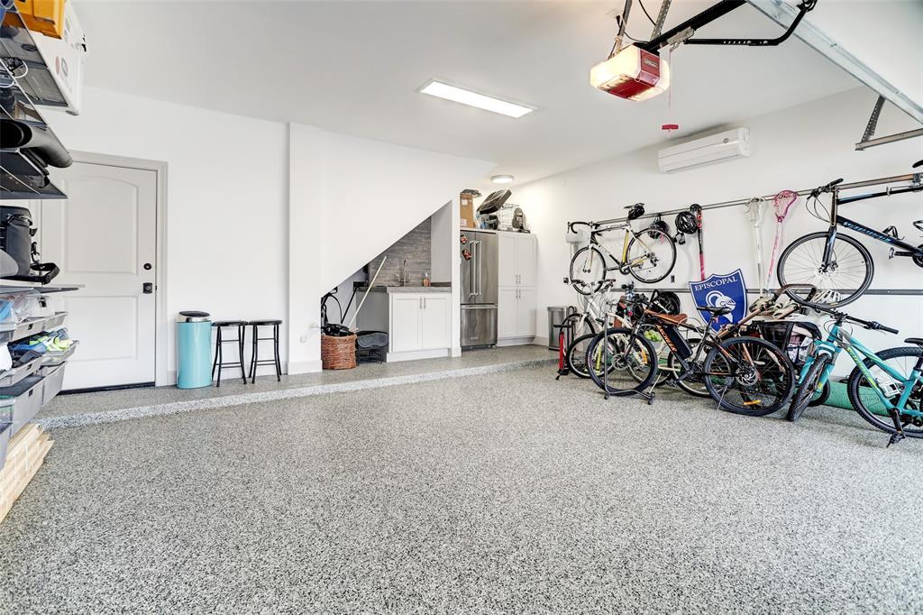 Garage has epoxy floors, refrigerator, sink, additional storage and has only been gently used.