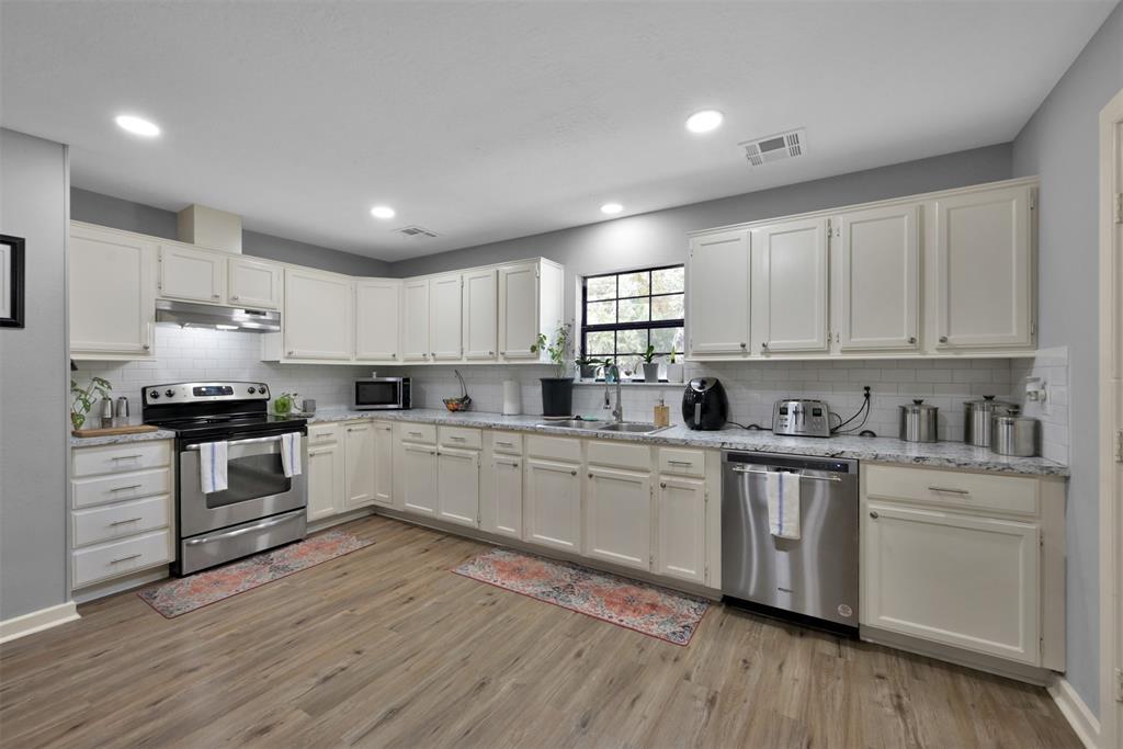 (Unit A) Generous storage space, countertop space, and a view of the front yard. Stainless steel appliances.