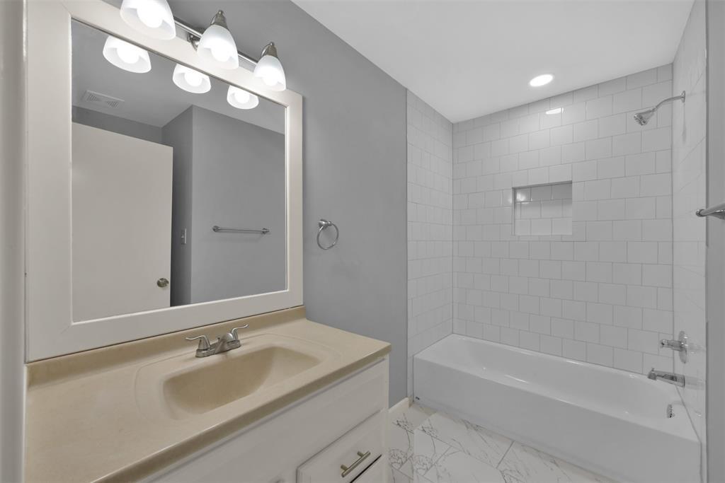 (Unit B) Here is the secondary bathroom for this unit. It has a lot of space so it wouldn't be hard to add an additional sink, countertop space, or a vanity in the future. The toilet is located across from the sink area.