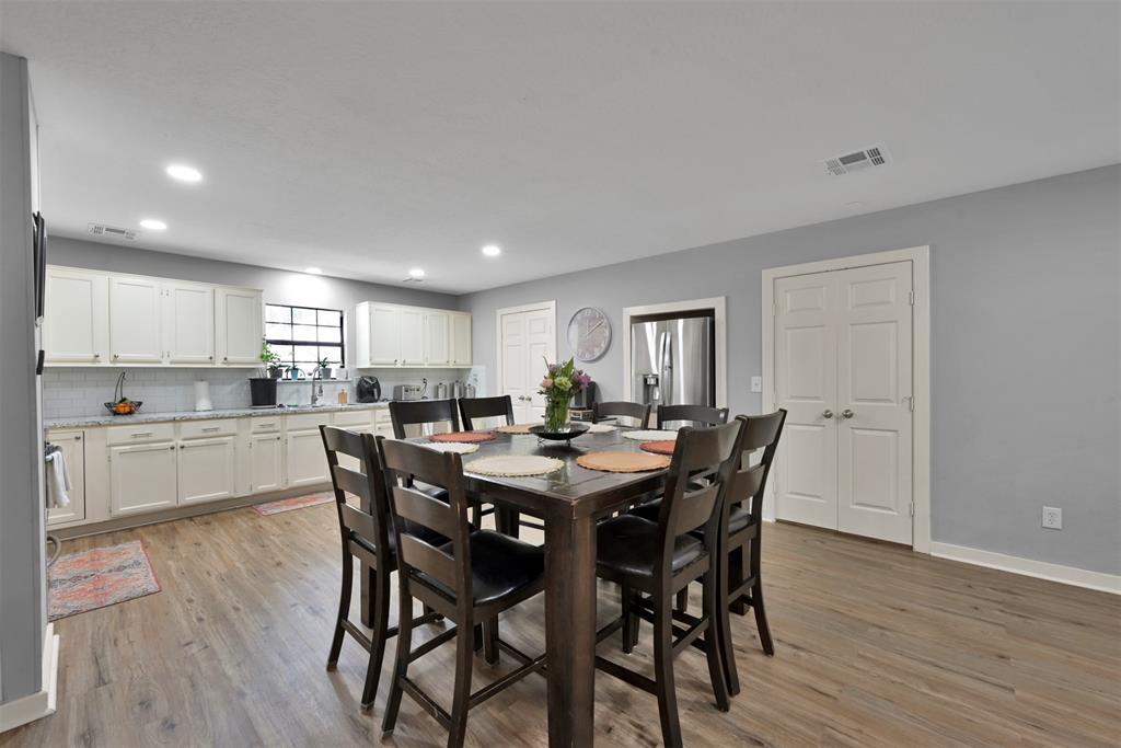 (Unit A) The dining area provides enough space for a large table. Utility room is through the double doors on the right, and the large pantry is through the double doors towards the center of this photo.