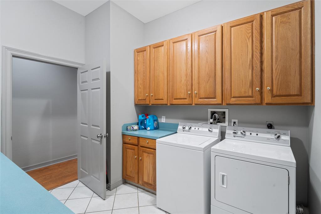 The utility room is spacious and has ample storage, making it convenient to work in.