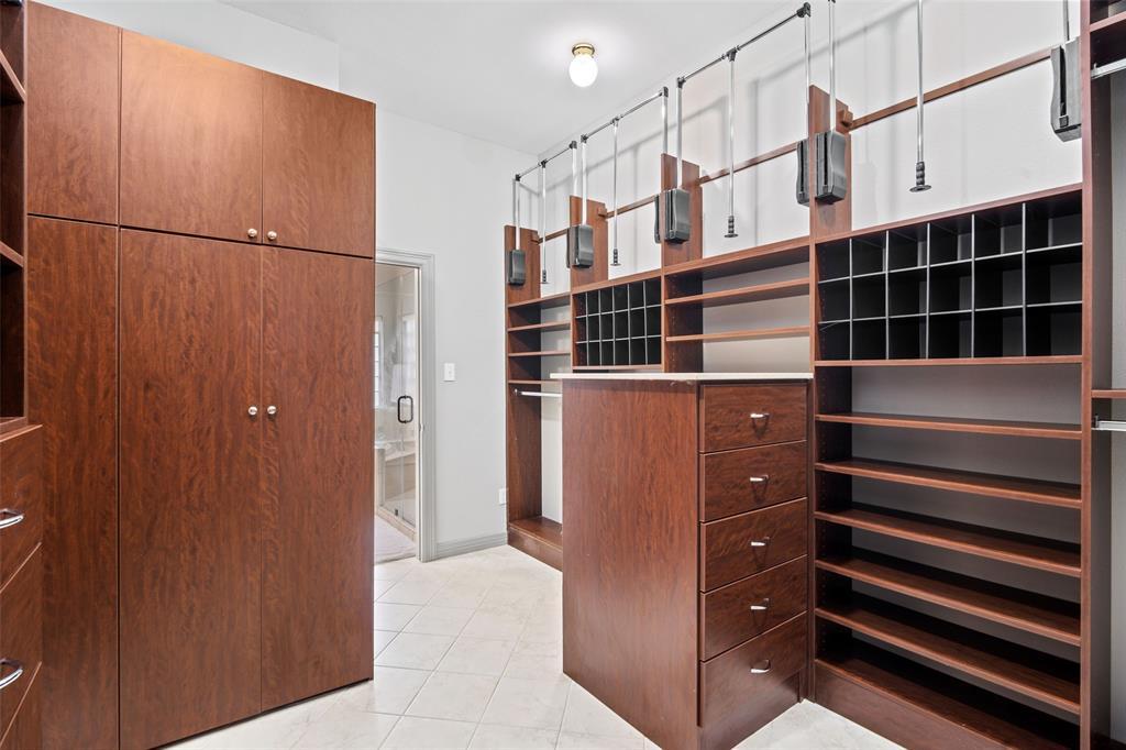 Here's a rewritten version of the text: "Here is another angle of the amazing primary walk-in closet with built-in storage." There were no spelling, grammar or punctuation errors in the original text, so I didn't have to correct anything.