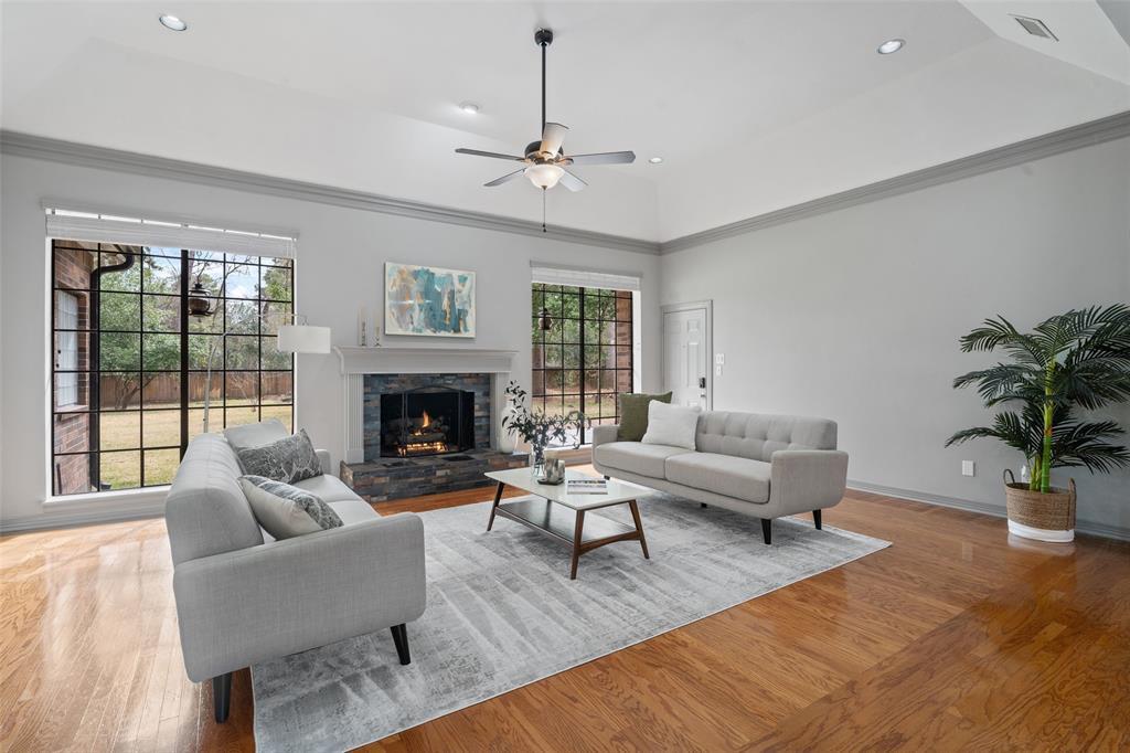 A clear view of the fireplace in the living room with ample natural light streaming in from the large windows.